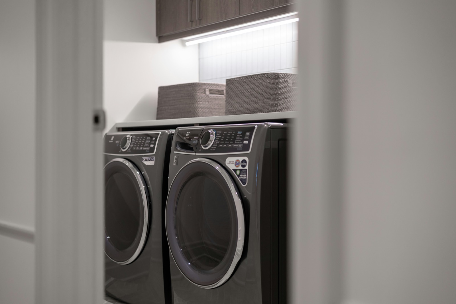 Front-load washer and dryer side by side in a home laundry room